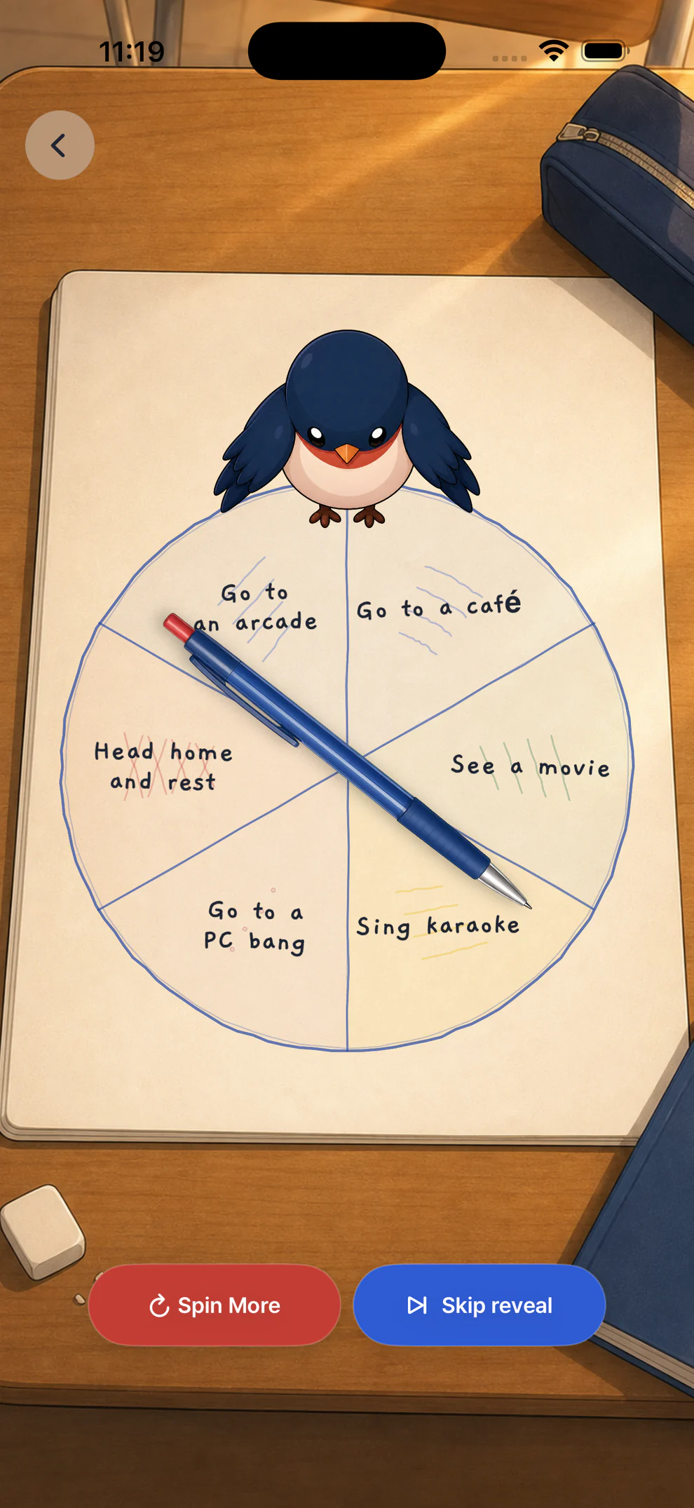 K-Picker Pen Spin pointing to one of six after-school choices on a notebook.